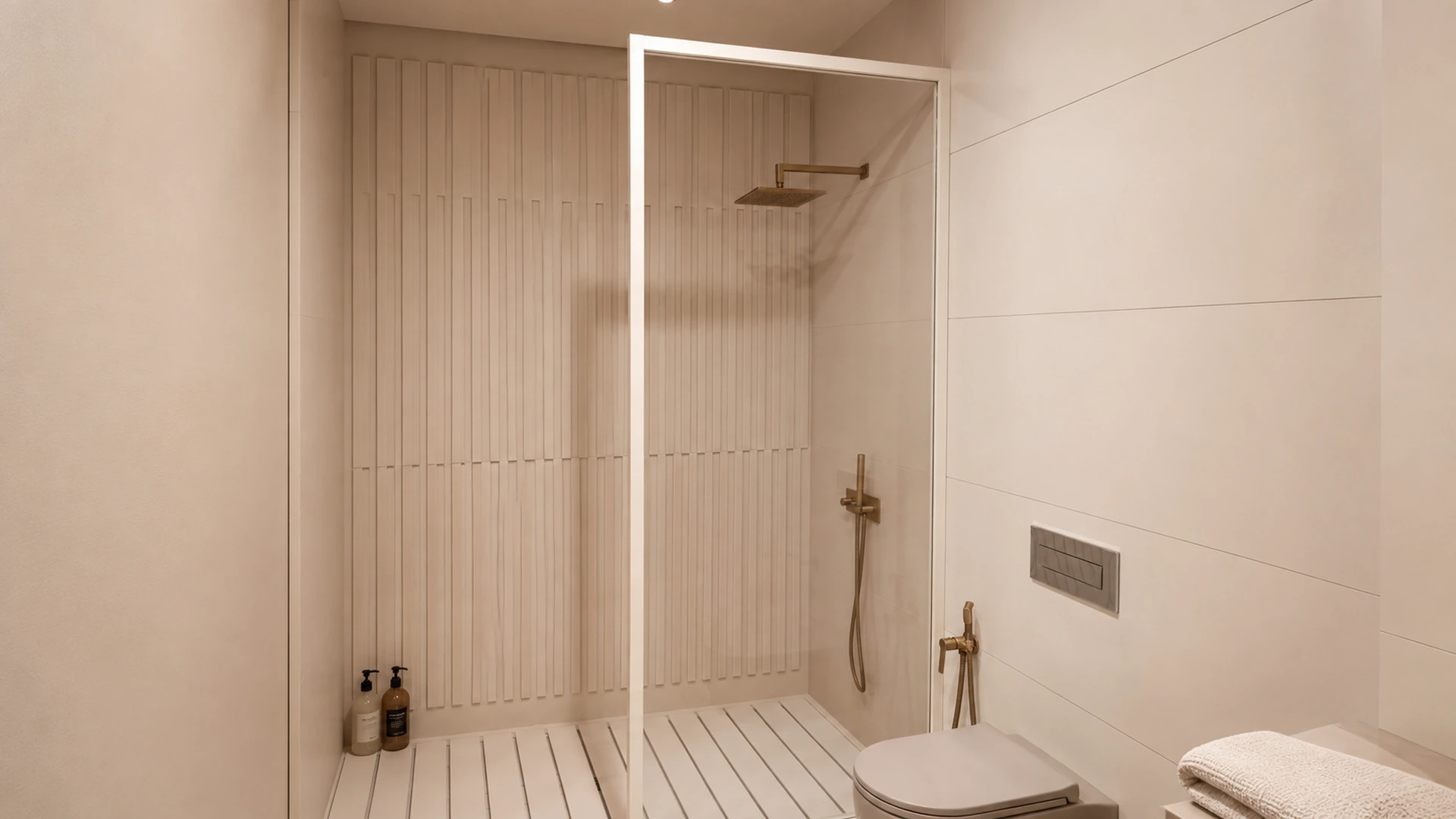 Light bathroom with a level-access shower, ribbed wall finish and brass taps.