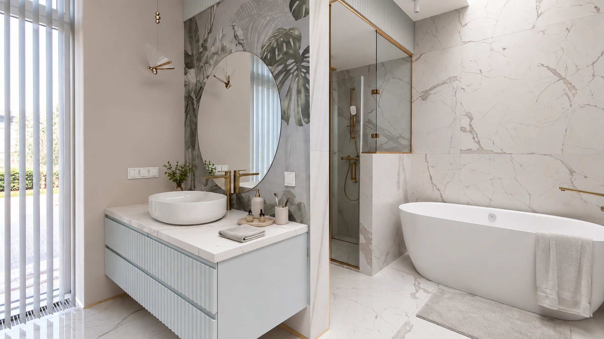 Wall-mounted vanity with fluted fronts, marble countertop, oval mirror and brass details.
